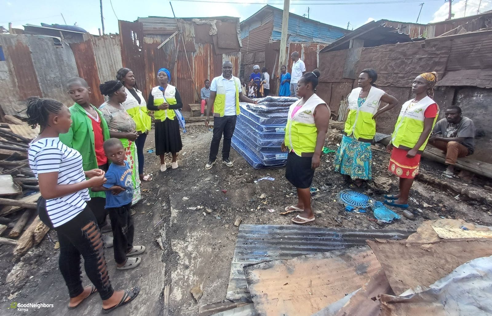 Families in Korogocho receiving mattresses and blankets after the fire