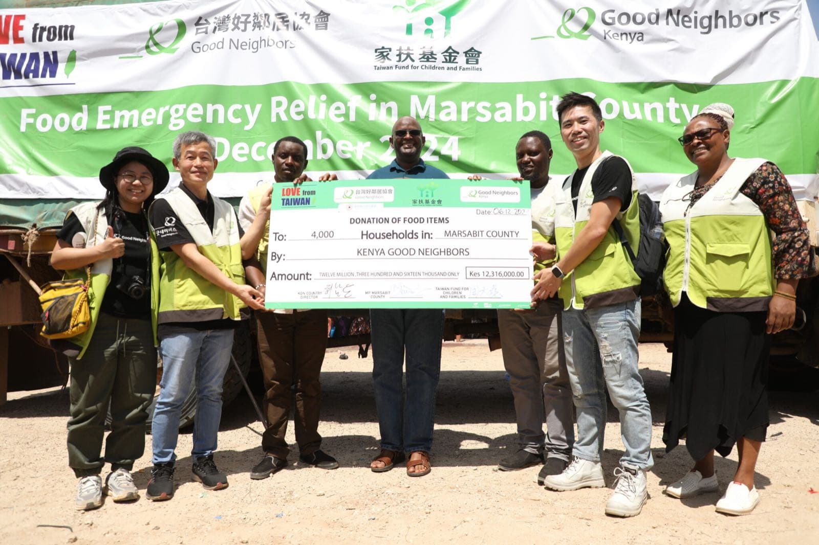 Good Neighbors staff and partners presenting the food relief donation for Marsabit County
