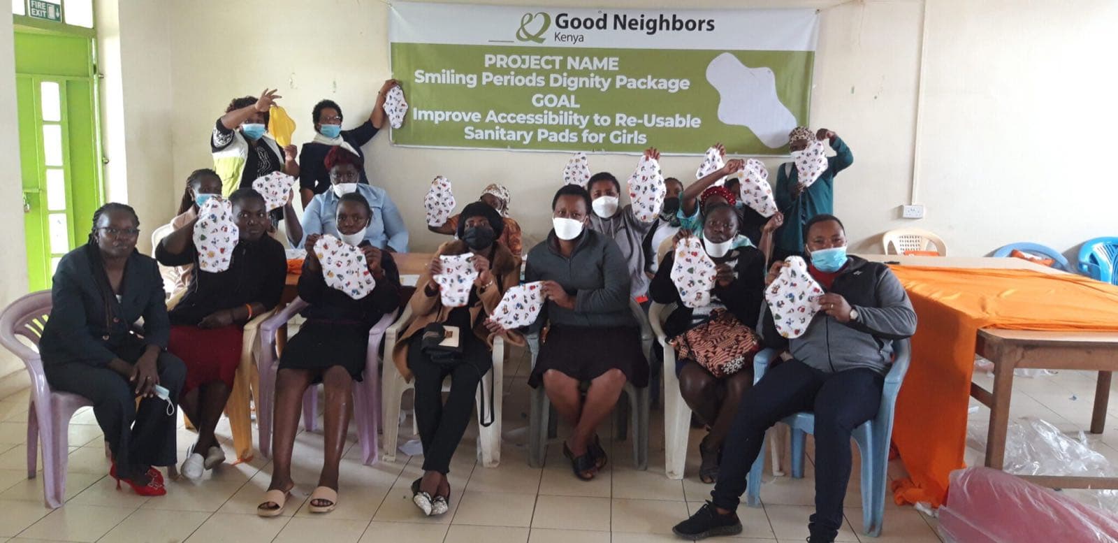 Schoolgirls holding Smiling Periods dignity packages