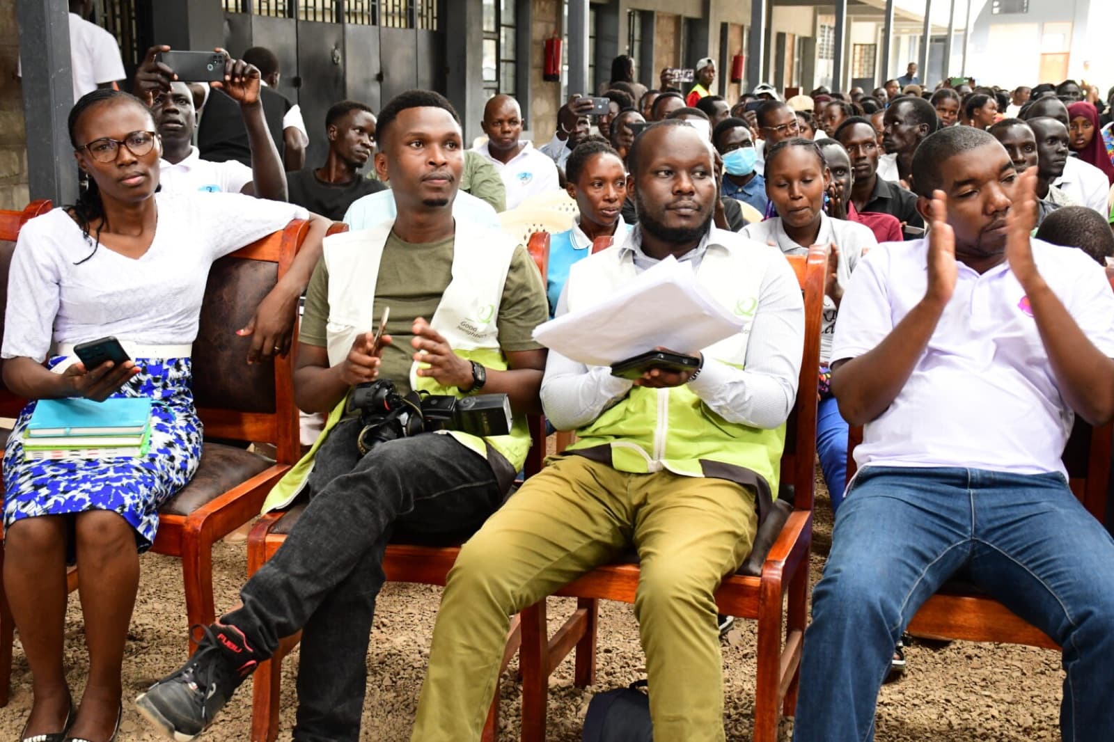 Good Neighbors staff and young people in the audience at a public forum